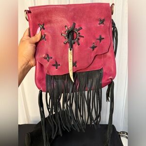Pink leather purse. Leather fringe, bone closure. No crossbody strap.